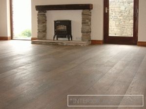 Flooring in the interior of a large living room with fireplace